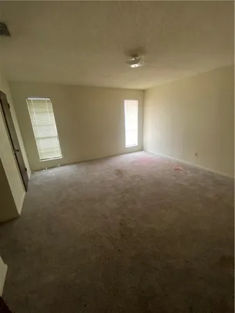 a view of an empty room and closet area