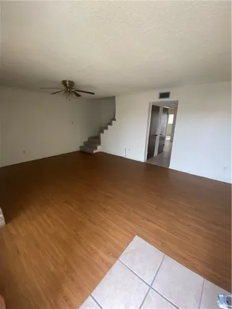 a kitchen with a sink a refrigerator and cabinets