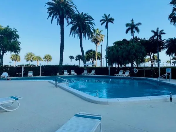 a view of a swimming pool and a longer chairs