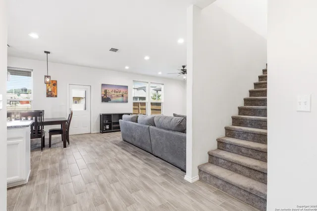 a living room with furniture and wooden floor