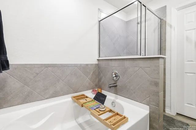 a bathroom with a bathtub and shower