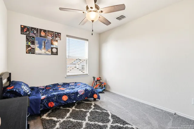 a bedroom with furniture and a window