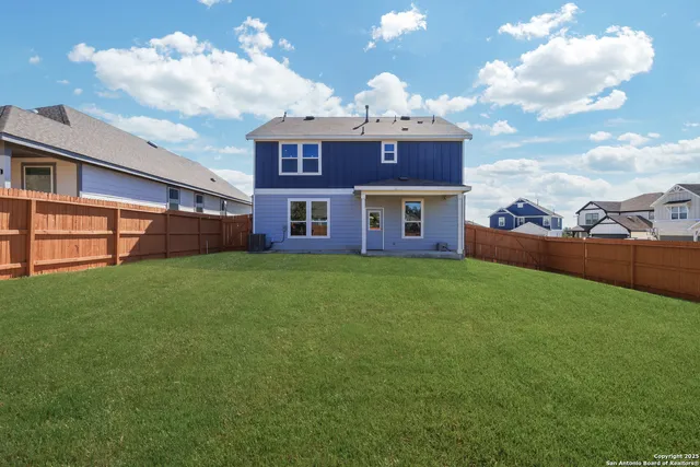 a view of a house with a backyard and porch