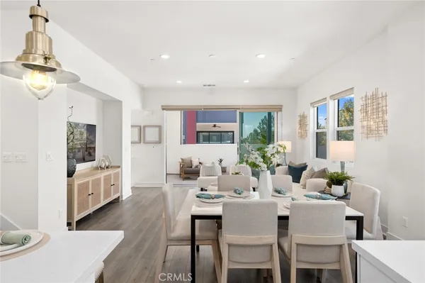 a view of a dining room with furniture and a chandelier
