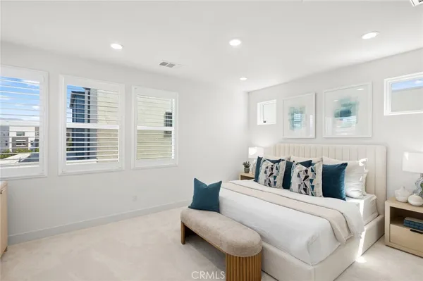 a bedroom with a bed and a couch