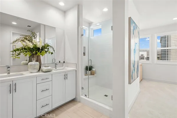 a bathroom with a granite countertop sink a shower a mirror and a shower