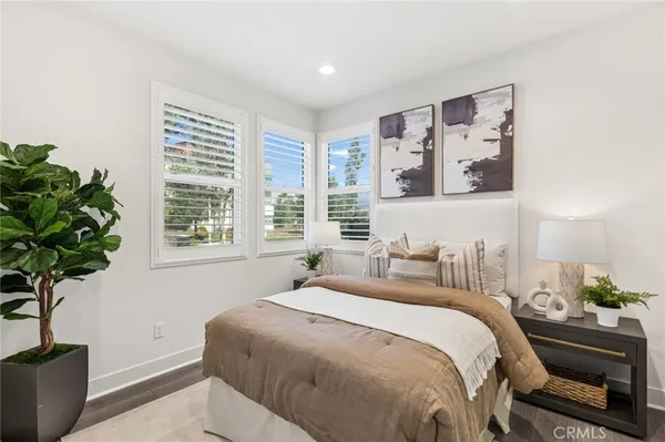 a bedroom with a bed and a potted plant