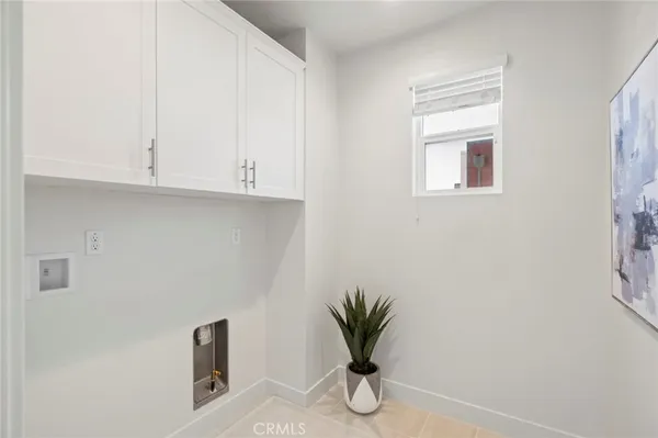 a view of small space with wooden floor and cabinets