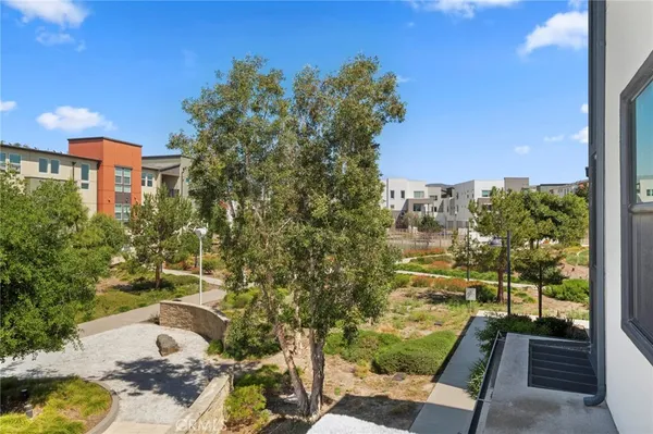 a view of a balcony with yard