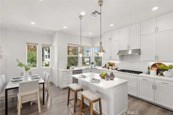 a kitchen that has a lot of cabinets in it and appliances