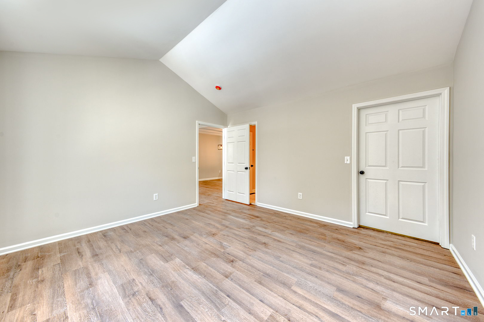 159 Jennifer Lane, Unit 159 Newtown, CT 06482 - Photo 19 of 28 a view of an empty room with wooden floor