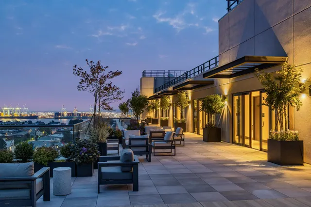 a view of a patio with a table and chairs under an umbrella