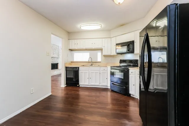 a kitchen with a refrigerator and a stove top oven