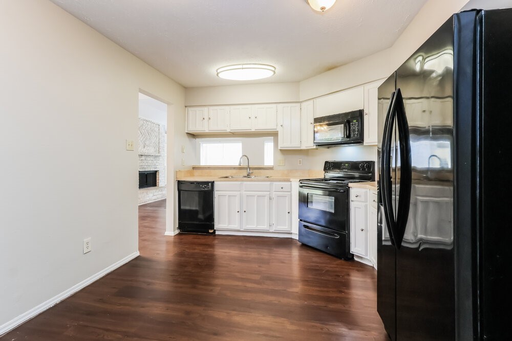 4606 Lost Lake Lane Spring, TX 77388 - Photo 8 of 16 a kitchen with a refrigerator and a stove top oven