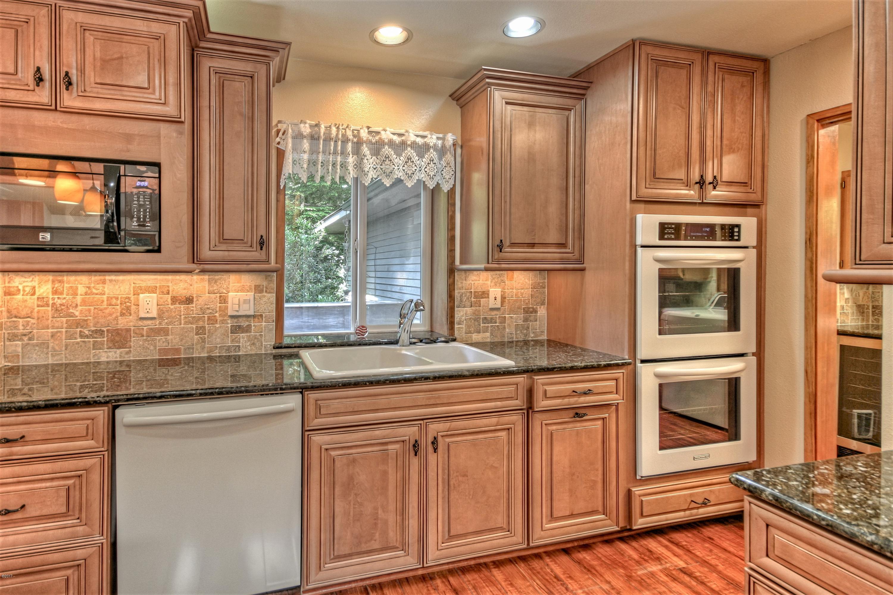 17 Big Tree Road Gleneden Beach, OR 97388 - Photo 12 of 52 a kitchen with stainless steel appliances granite countertop a stove and a microwave