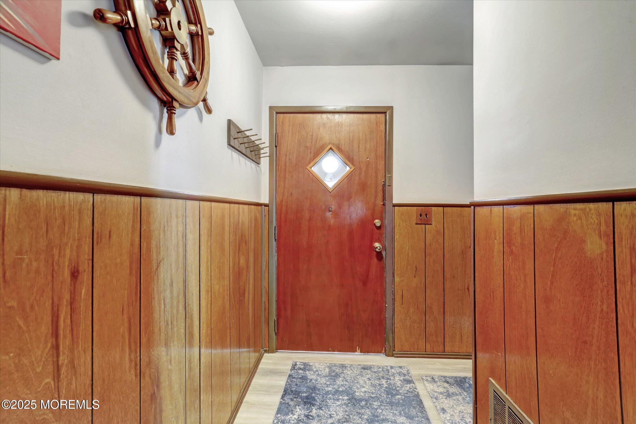 1 Peach Tree Road Oakhurst, NJ 07755 - Photo 12 of 42 a view of a entryway with wooden walls