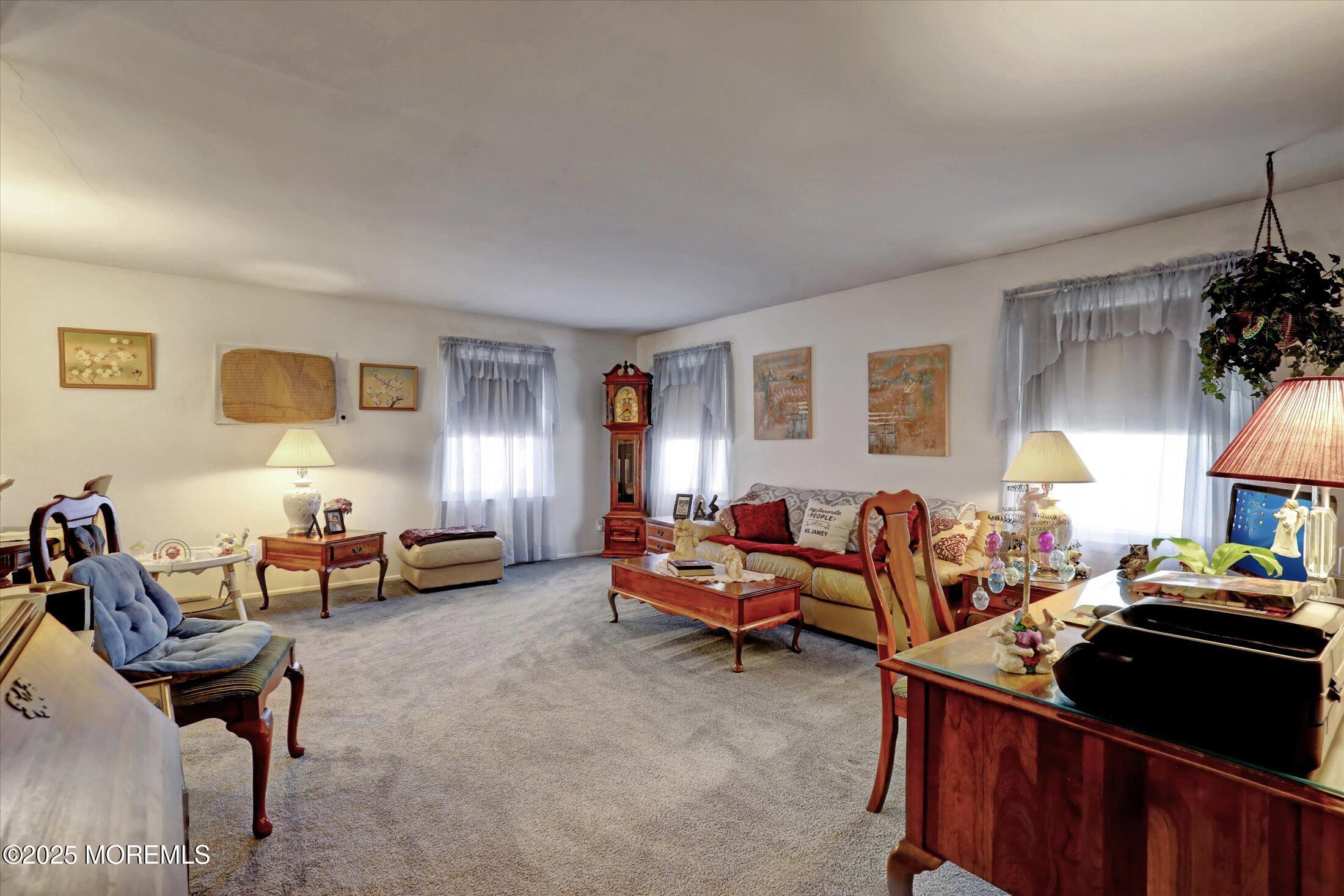 1 Peach Tree Road Oakhurst, NJ 07755 - Photo 26 of 42 a living room with furniture a lamp and a window