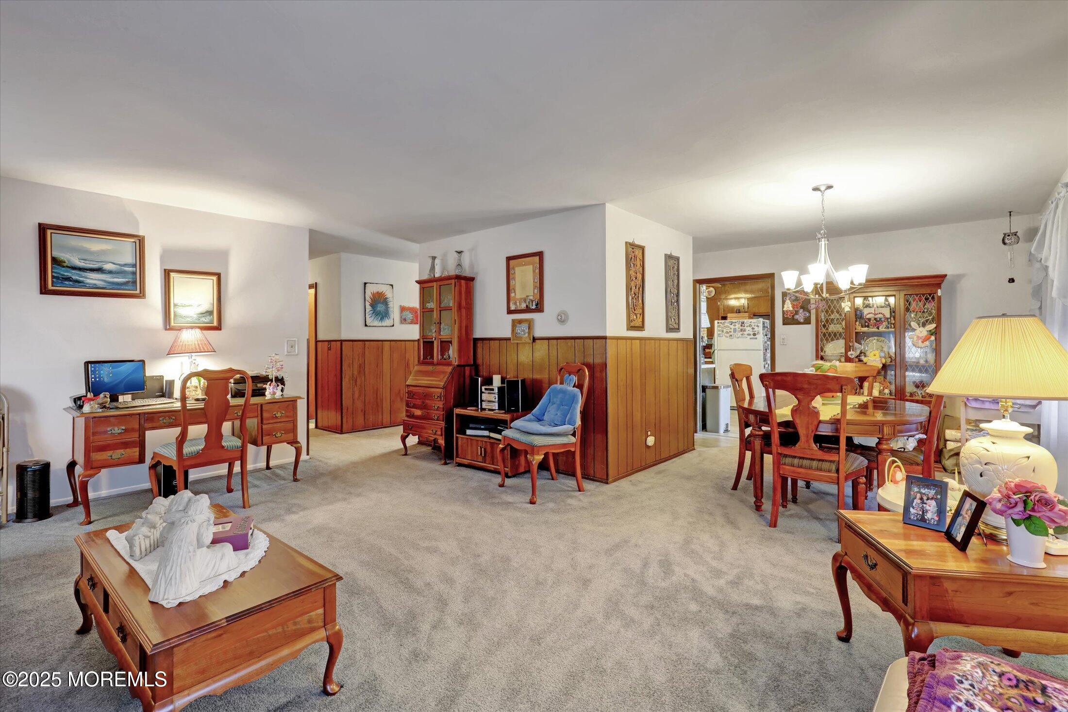 1 Peach Tree Road Oakhurst, NJ 07755 - Photo 28 of 42 a living room filled with furniture and a dining table with wooden floor