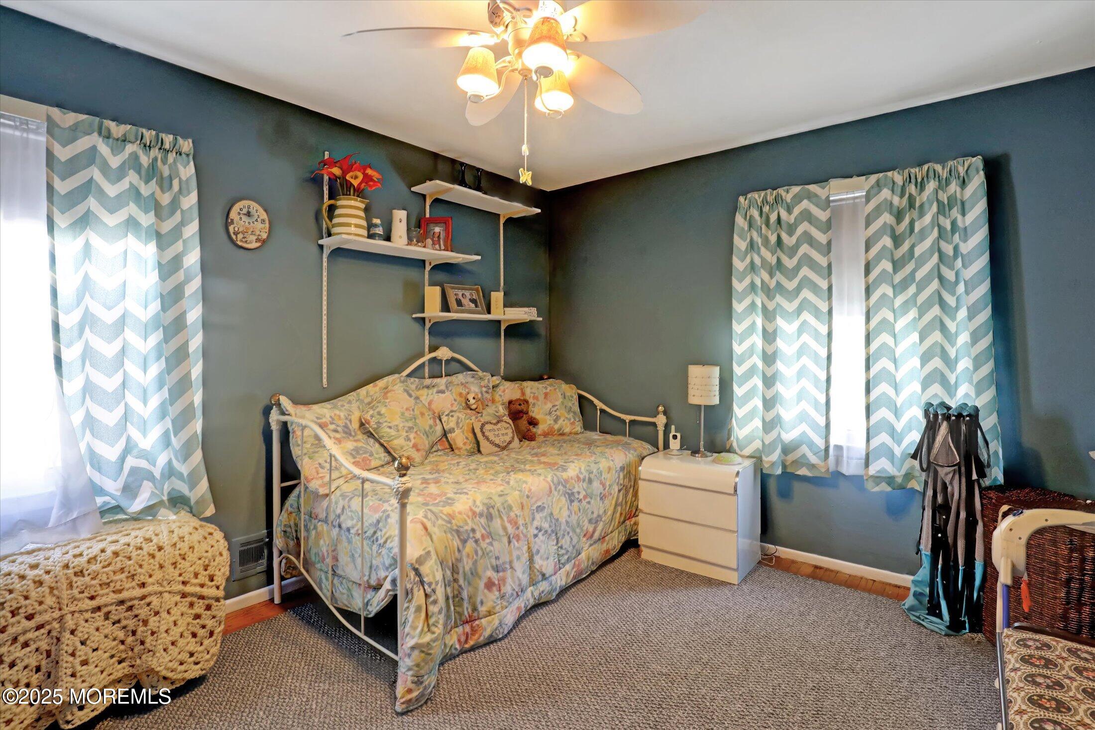 1 Peach Tree Road Oakhurst, NJ 07755 - Photo 30 of 42 a bedroom with a bed and a chandelier