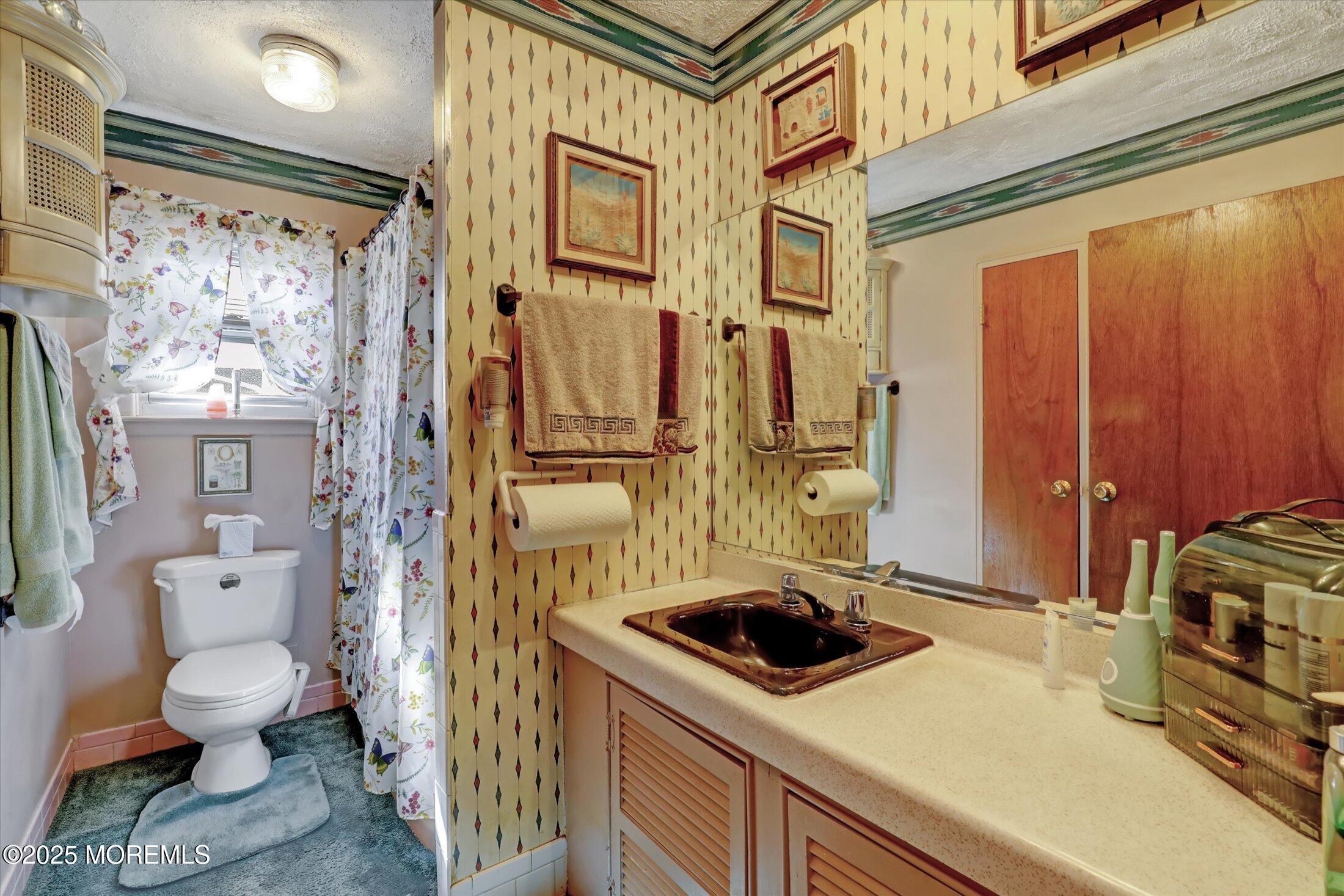 1 Peach Tree Road Oakhurst, NJ 07755 - Photo 31 of 42 a bathroom with a sink a toilet and shower