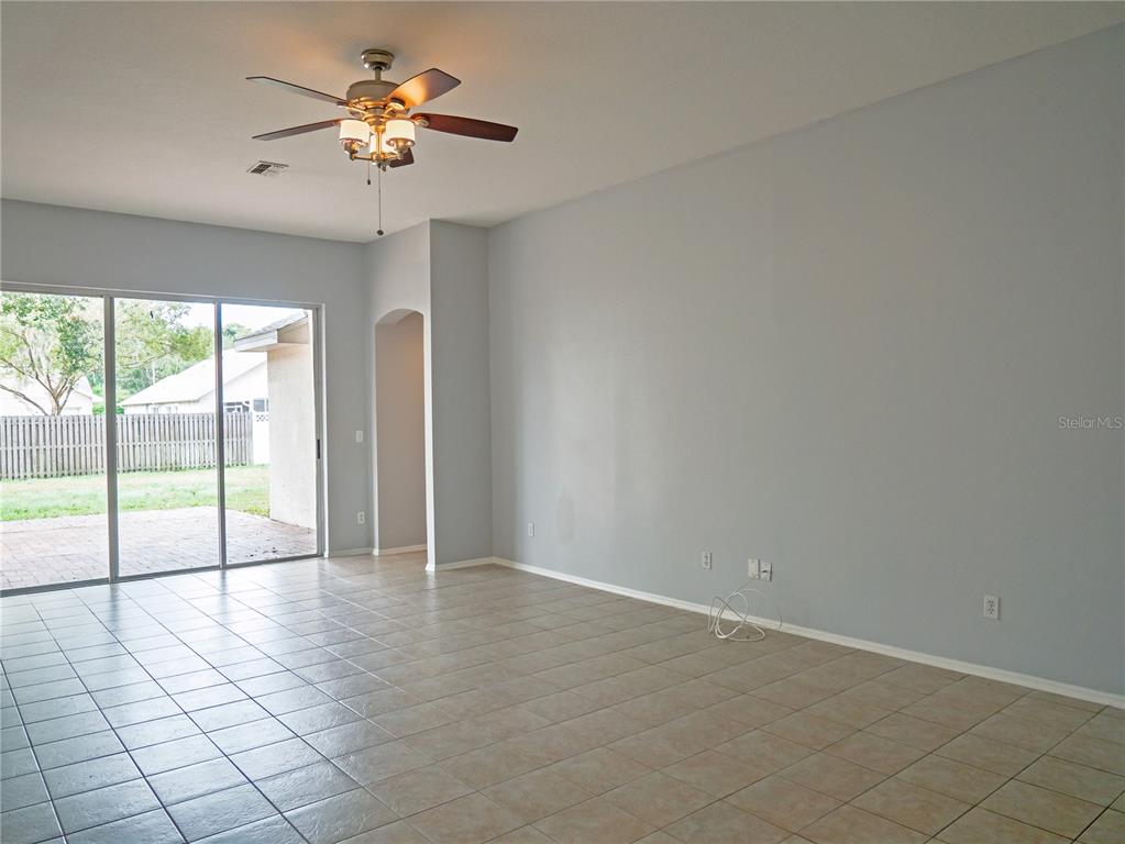 4768 Ridgemoor Circle Palm Harbor, FL 34685 - Photo 12 of 41 an empty room with windows and chandelier fan