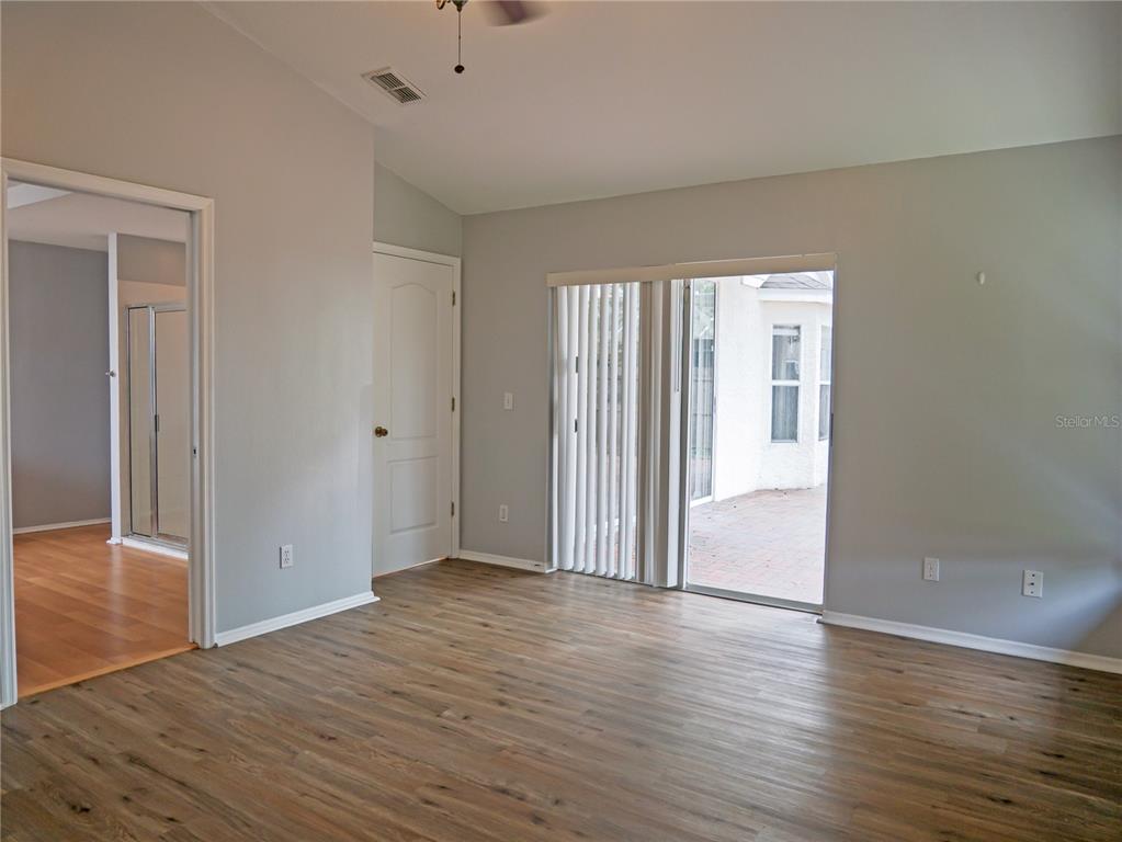 4768 Ridgemoor Circle Palm Harbor, FL 34685 - Photo 19 of 41 wooden floor in an empty room with a window