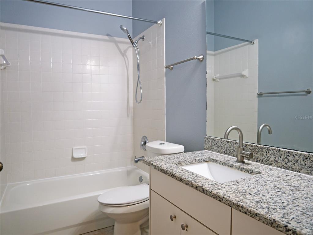 4768 Ridgemoor Circle Palm Harbor, FL 34685 - Photo 24 of 41 a bathroom with a granite countertop sink toilet and shower