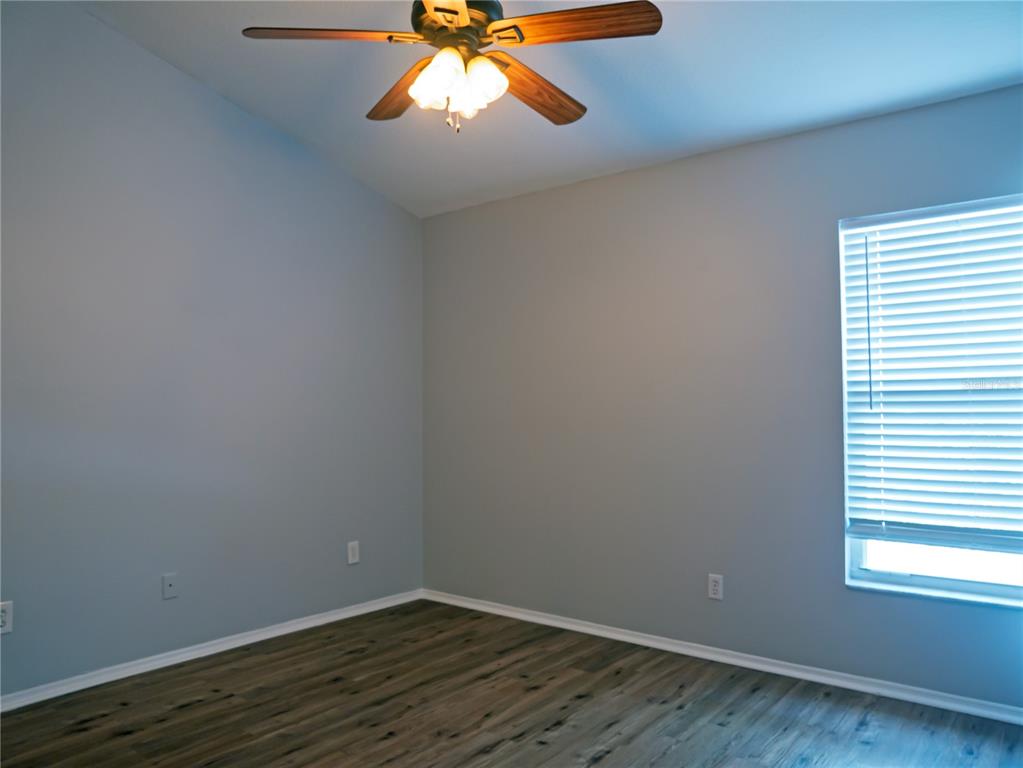 4768 Ridgemoor Circle Palm Harbor, FL 34685 - Photo 25 of 41 an empty room with wooden floor and windows