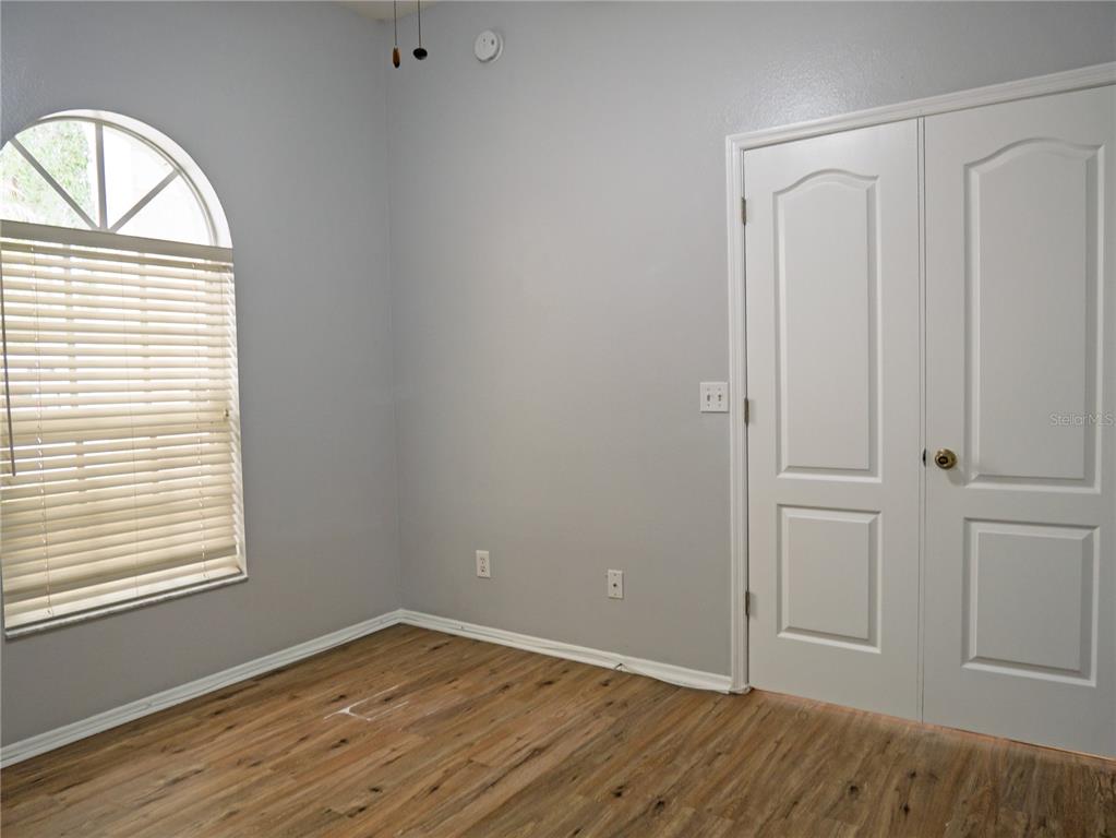 4768 Ridgemoor Circle Palm Harbor, FL 34685 - Photo 26 of 41 an empty room with wooden floor closet and windows