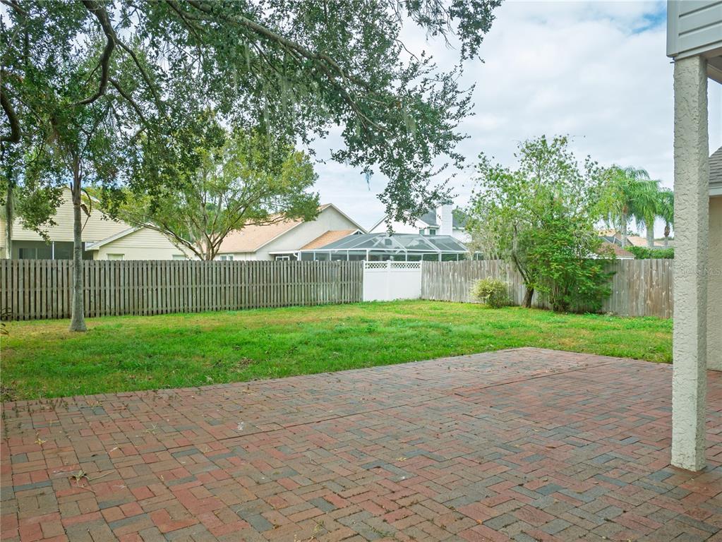 4768 Ridgemoor Circle Palm Harbor, FL 34685 - Photo 31 of 41 a view of a house with a yard and a large trees
