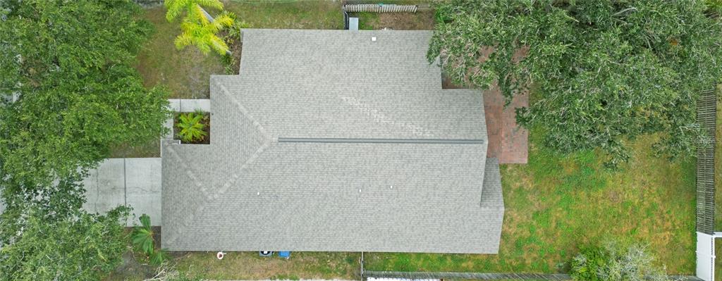4768 Ridgemoor Circle Palm Harbor, FL 34685 - Photo 35 of 41 an aerial view of a house with a yard and large trees