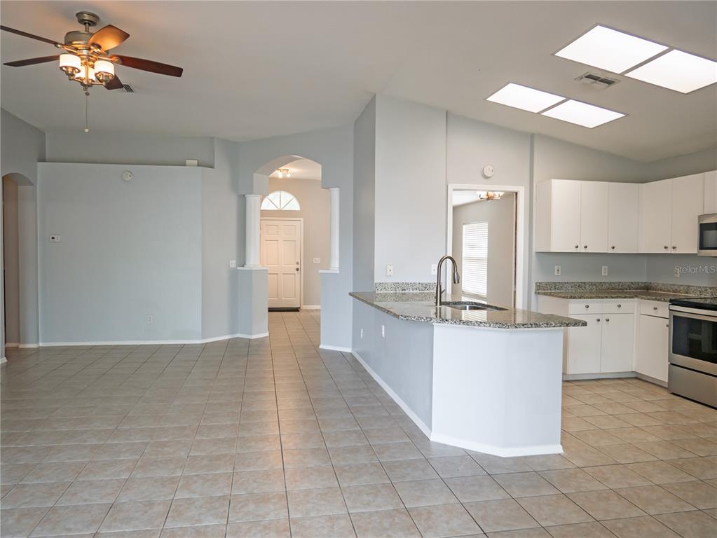 4768 Ridgemoor Circle Palm Harbor, FL 34685 - Photo 7 of 41 a large kitchen with cabinets and stainless steel appliances