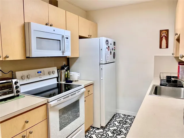 a kitchen with a refrigerator and a stove