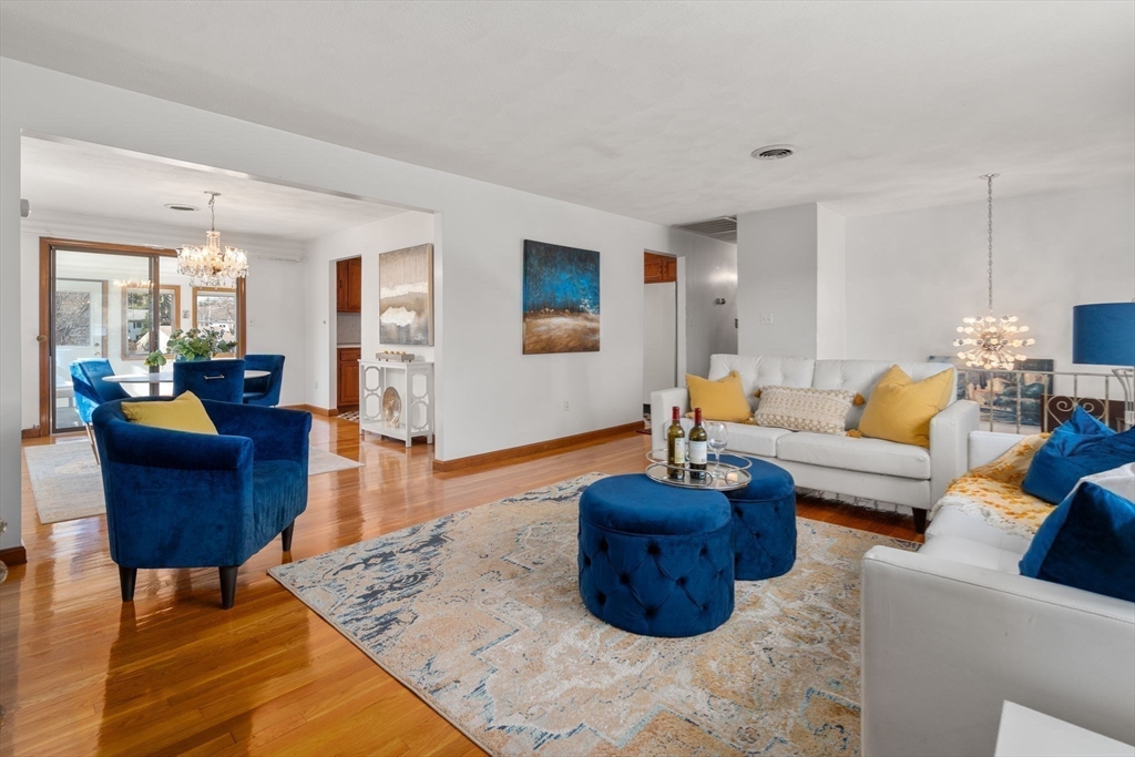 8 Sycamore Lane Saugus, MA 01906 - Photo 1 of 39 a living room with furniture a rug and a dining table