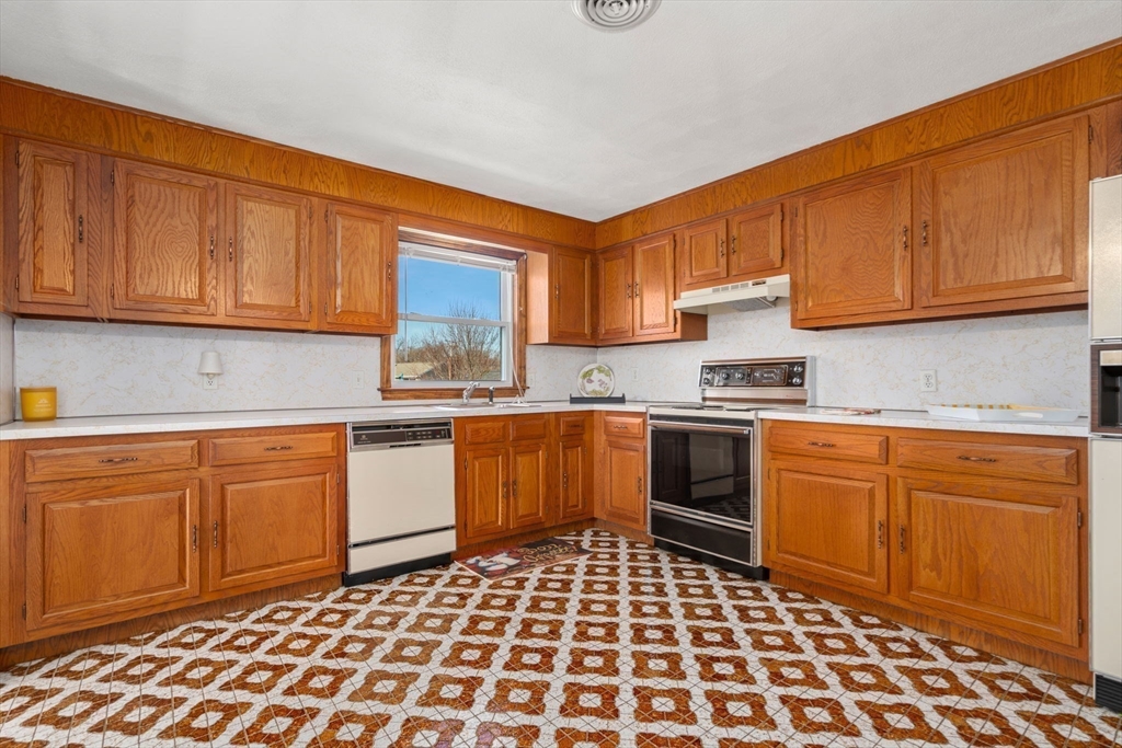 8 Sycamore Lane Saugus, MA 01906 - Photo 11 of 39 a kitchen with granite countertop stainless steel appliances and cabinets