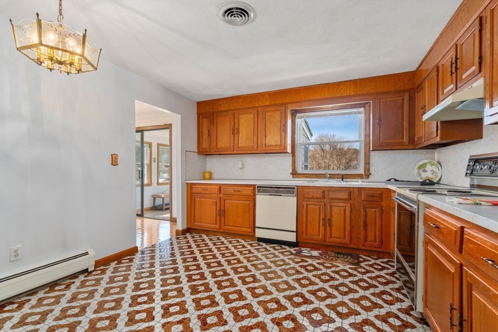 8 Sycamore Lane Saugus, MA 01906 - Photo 12 of 39 a kitchen with a sink a stove cabinets and a window