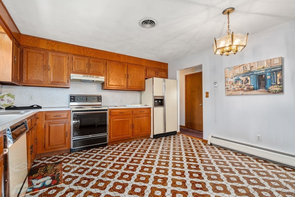 8 Sycamore Lane Saugus, MA 01906 - Photo 13 of 39 a kitchen with a stove a sink and a refrigerator
