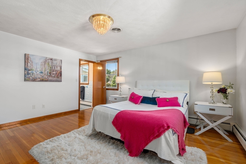 8 Sycamore Lane Saugus, MA 01906 - Photo 15 of 39 a bedroom with a bed and wooden floor