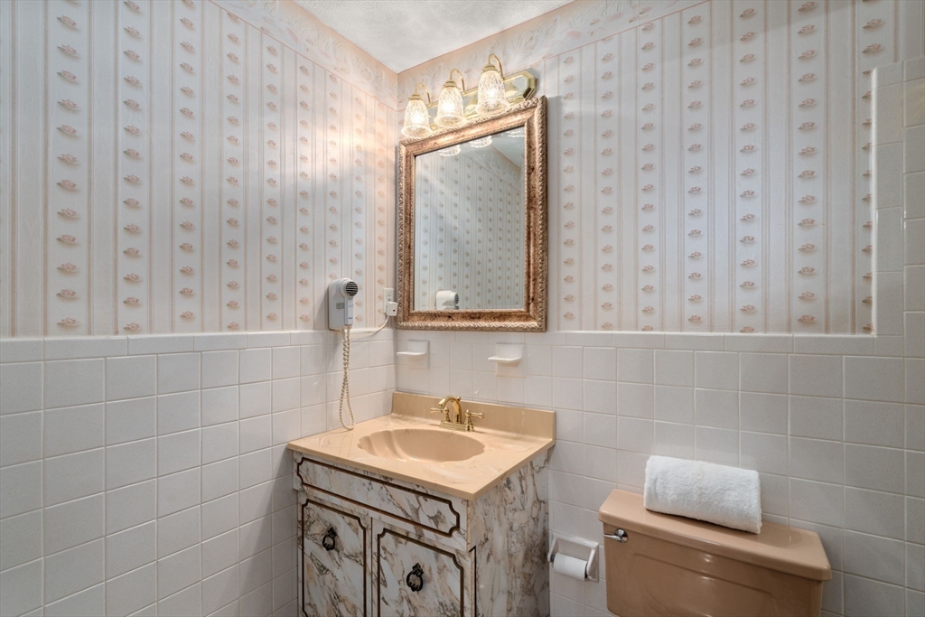 8 Sycamore Lane Saugus, MA 01906 - Photo 19 of 39 a bathroom with a granite countertop sink and a mirror