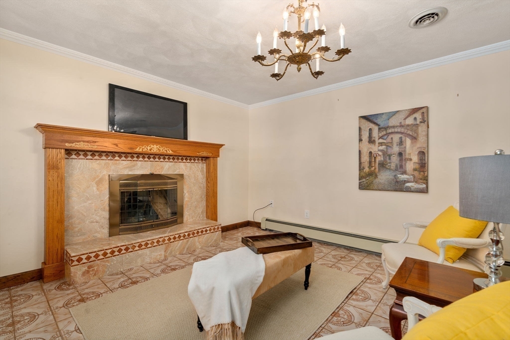8 Sycamore Lane Saugus, MA 01906 - Photo 20 of 39 a living room with furniture and a fireplace