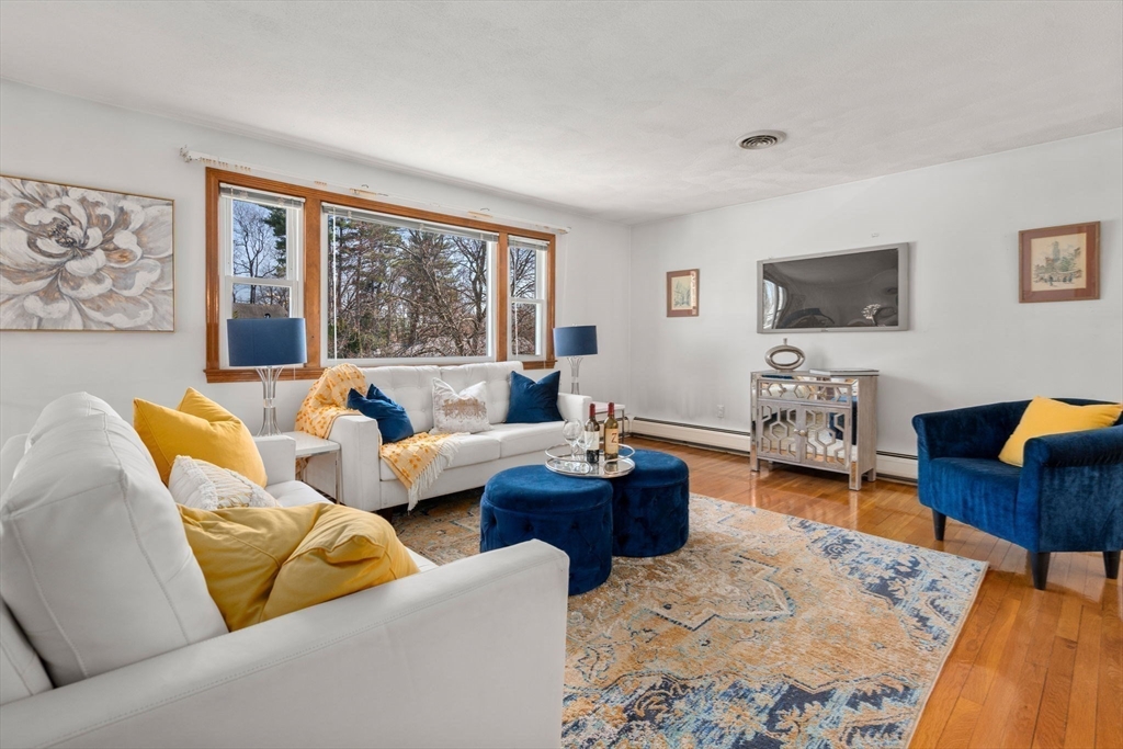8 Sycamore Lane Saugus, MA 01906 - Photo 2 of 39 a living room with furniture and a flat screen tv