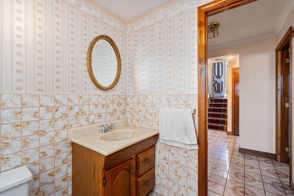 8 Sycamore Lane Saugus, MA 01906 - Photo 23 of 39 a bathroom with a sink and a mirror