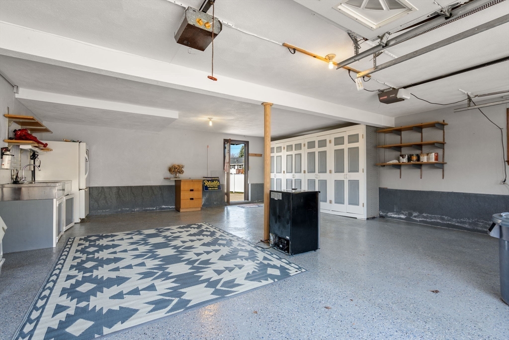 8 Sycamore Lane Saugus, MA 01906 - Photo 27 of 39 a view of a livingroom with a furniture staircase and a kitchen
