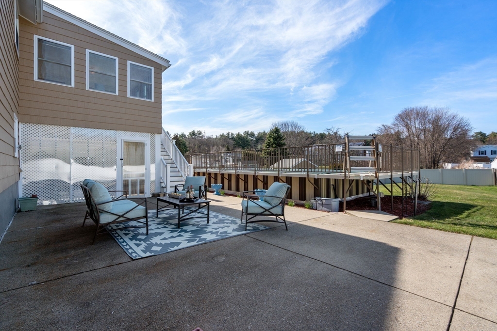 8 Sycamore Lane Saugus, MA 01906 - Photo 32 of 39 a view of a patio with a table and chairs