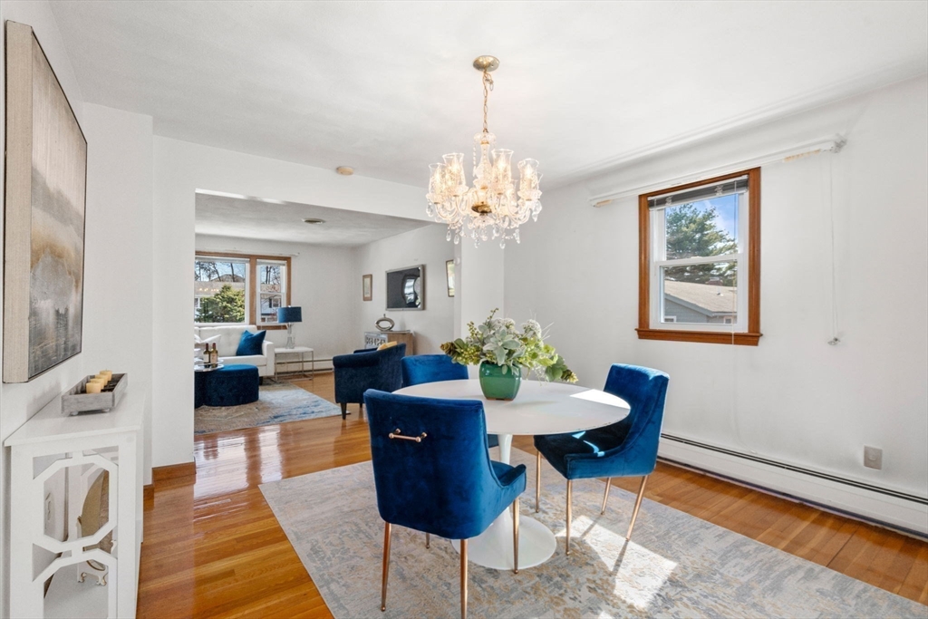 8 Sycamore Lane Saugus, MA 01906 - Photo 6 of 39 a living room with furniture and a chandelier