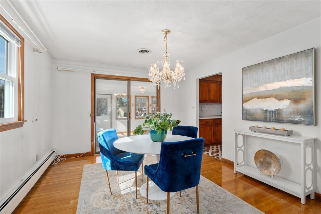 8 Sycamore Lane Saugus, MA 01906 - Photo 7 of 39 a dining room with furniture a chandelier and wooden floor