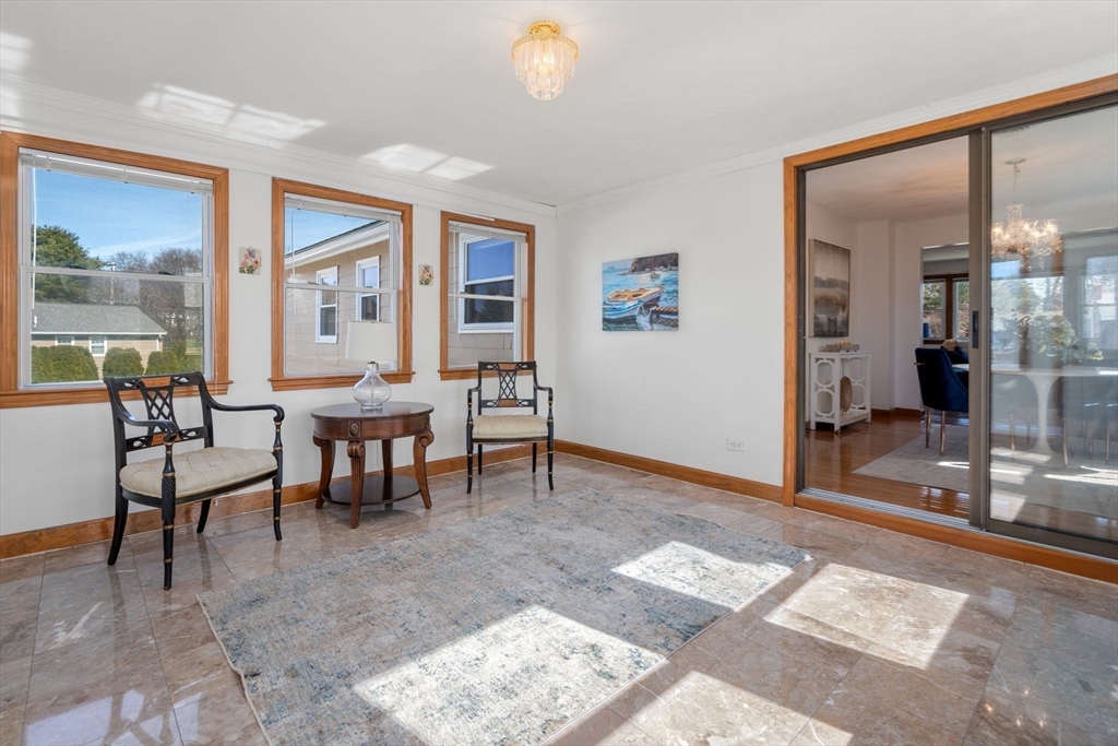 8 Sycamore Lane Saugus, MA 01906 - Photo 9 of 39 a living room with furniture and a floor to ceiling window