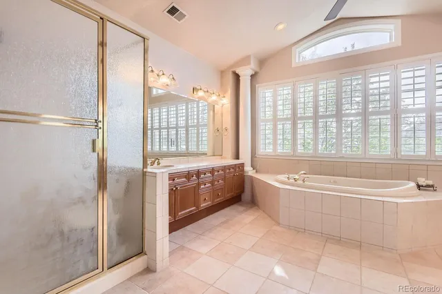 a spacious bathroom with a tub shower and sink