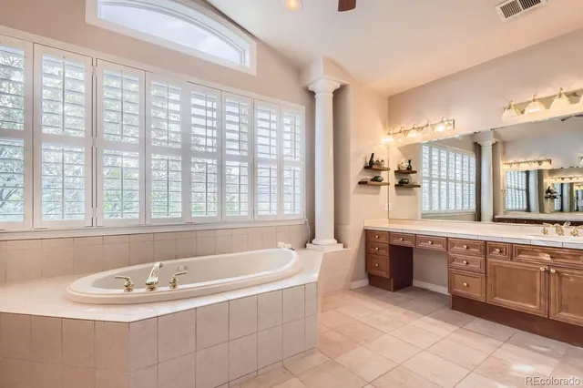 a bath tub sitting in a bathroom next to a window