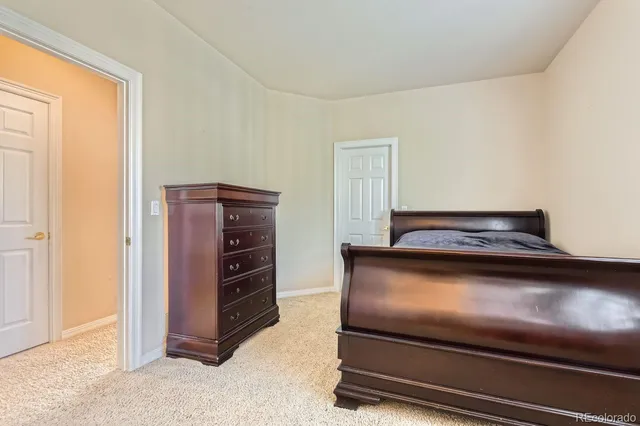 a soft toy sitting on a bed in a room